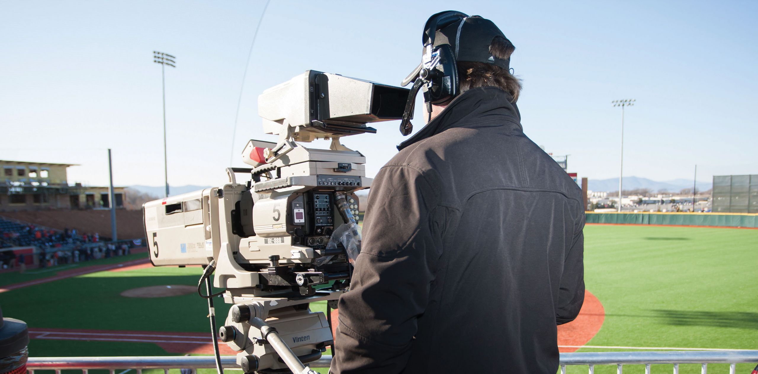 A cameraman covers a baseball game for LFSN.