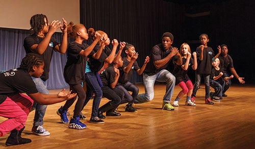 Joel Ledbetter (’14), an alumnus of Liberty University’s Department of Theatre Arts, performed with local elementary schoolchildren at the Academy of Fine Arts in downtown Lynchburg.