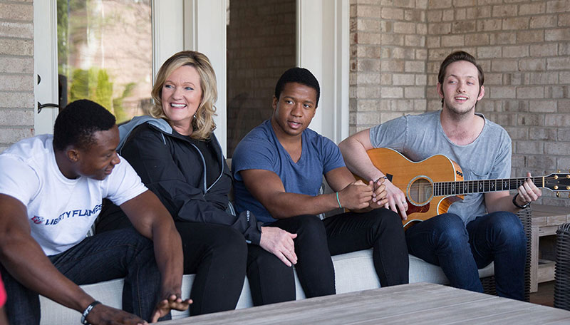  Karen Kingsbury spends time at home with three of her sons, left to right, Sean, Joshua, and Tyler. Sean and Joshua are students at Liberty.