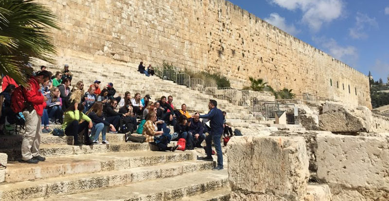 Dr. Ben Gutierrez, vice provost for academic administration and a professor of divinity, teaches students on the southern staircase of the Temple in Israel.