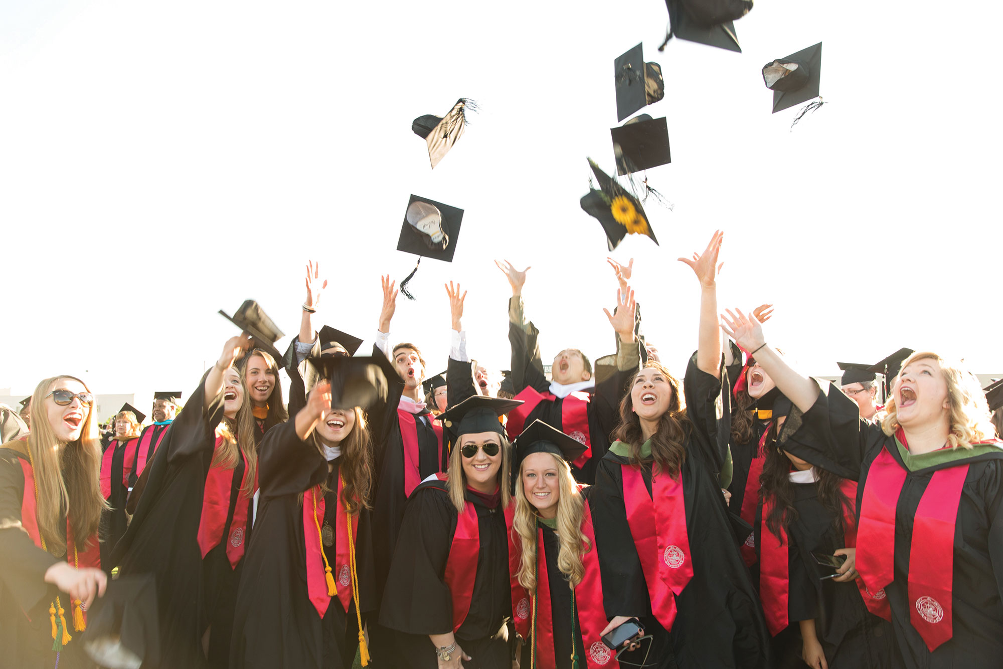 Graduates throw their caps in celebration at Liberty University's 43rd Commencement Ceremony.