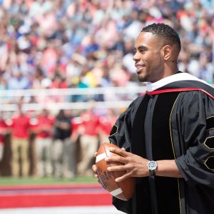 Rashad Jennings threw an autographed football into the crowd of graduates after his speech.