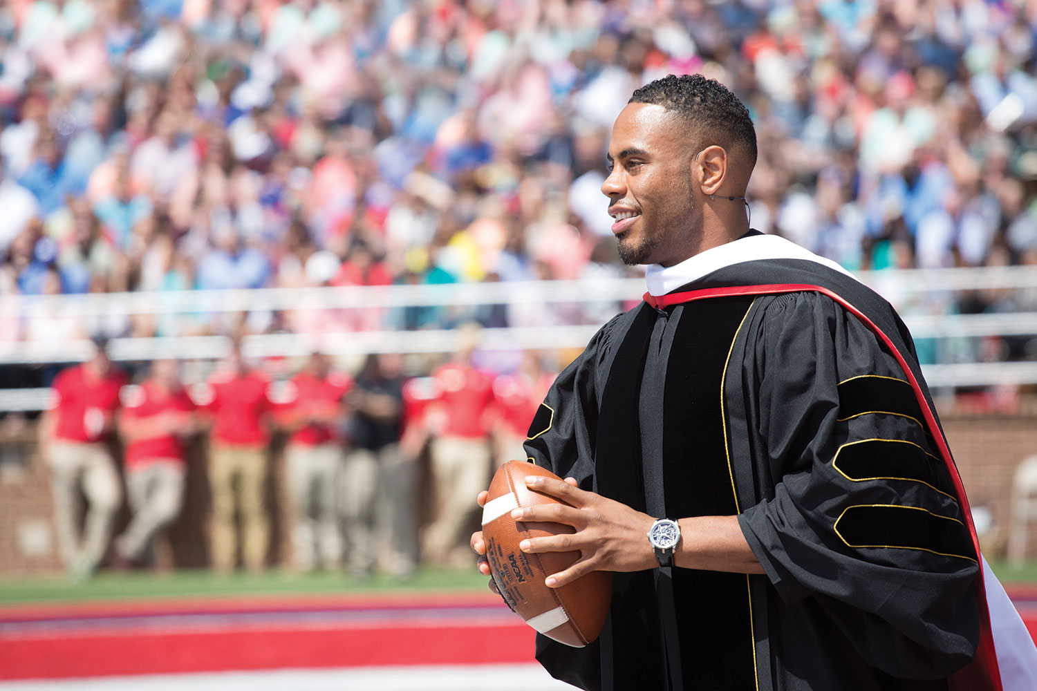 Rashad Jennings threw an autographed football into the crowd of graduates after his speech.