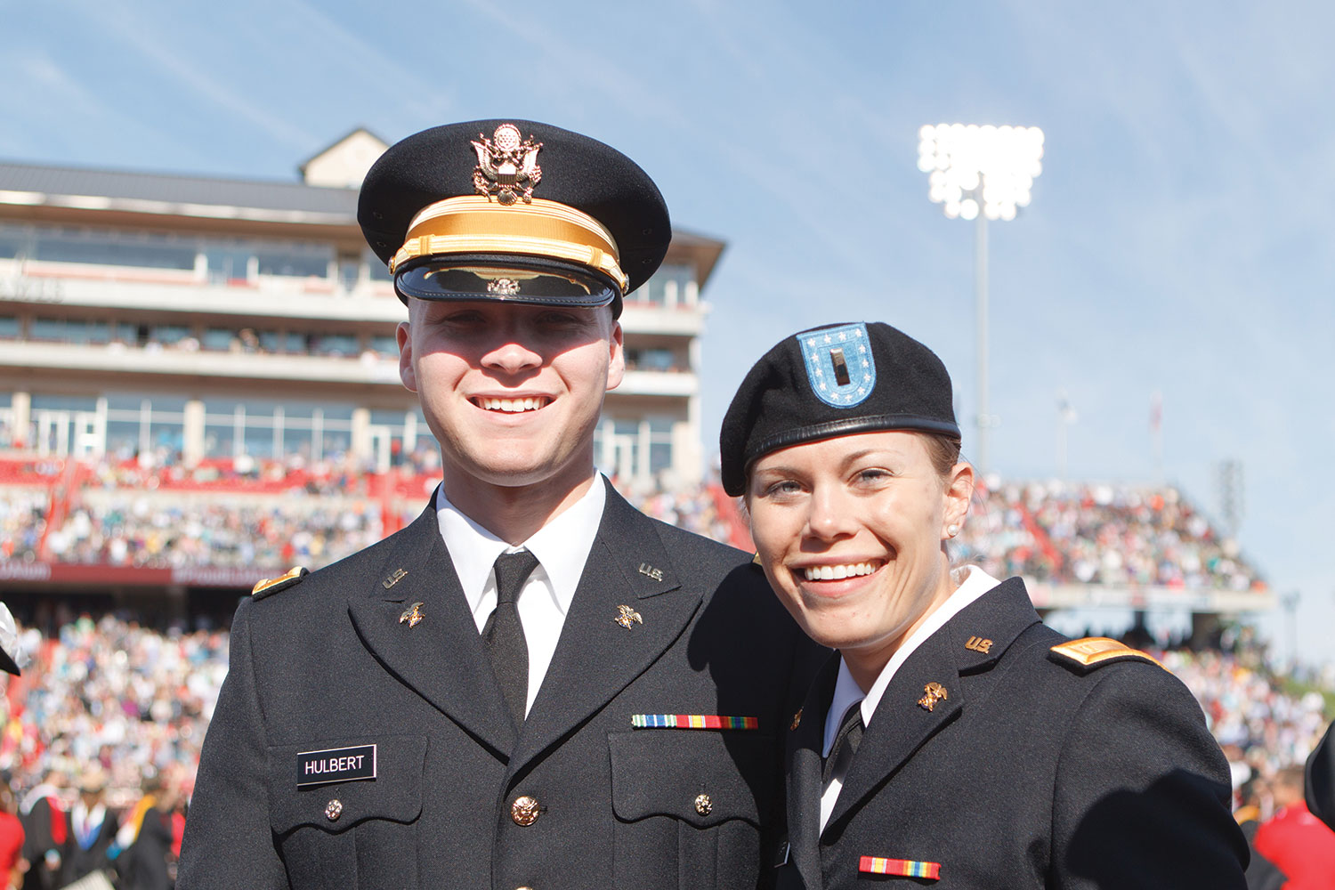 Two military graduates celebrate Commencement.