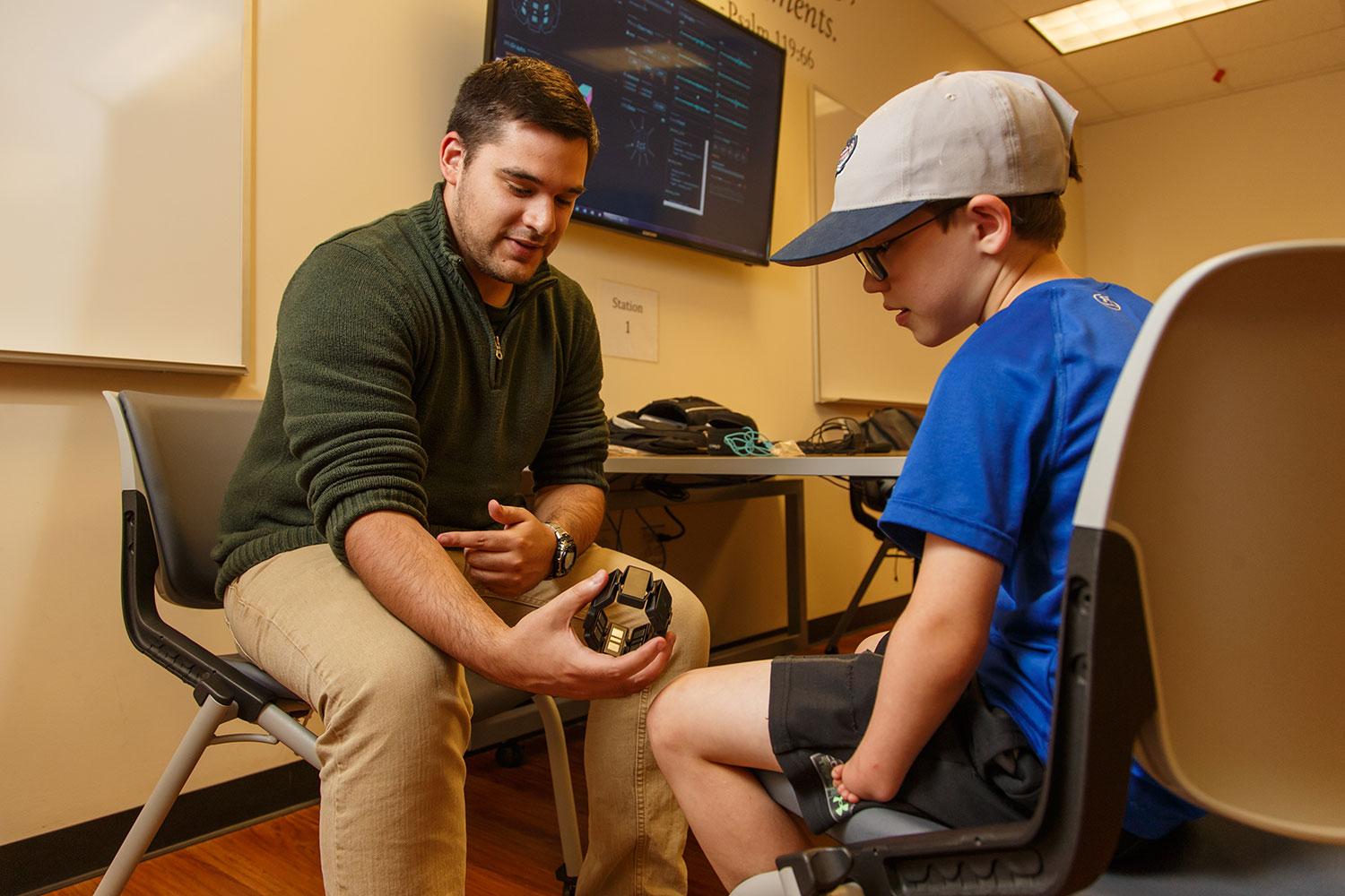 Rising electrical engineering student Kris Kennedy, who served as the EXO-Arm project manager, works with Connor McCombs, one of the recipients.