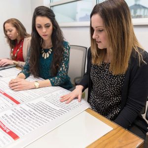 Recent graduate Brittané Dodwell (from left), rising senior Abigail Long, and Dr. Brianne Friberg, associate professor of psychology, discuss a psychology research project.