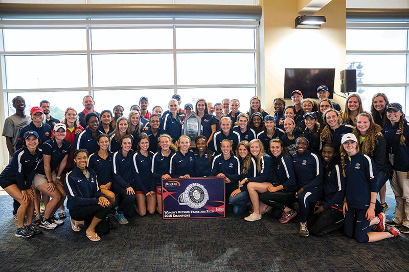 The women’s outdoor track & field team celebrates its own championship (win No. 19) at the conference title meet held at Liberty. (Photo by Kevin Manguiob)
