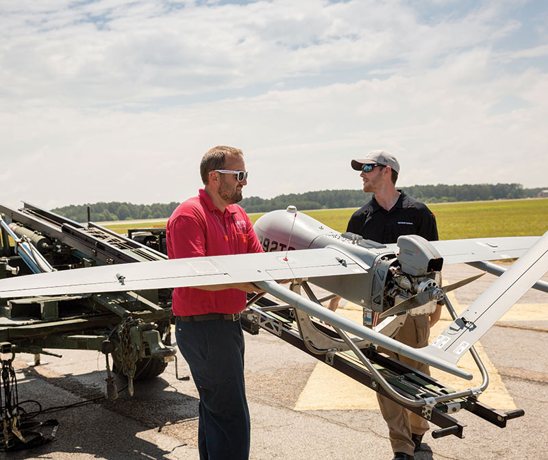 Liberty University assistant professor Steven Brinley and UAS student Luke Reddaway prepare to launch a Textron Systems Aerosonde Small Unmanned Aircraft at Textron's facility in Blackstone, Va. (Photo by Kevin Manguiob)