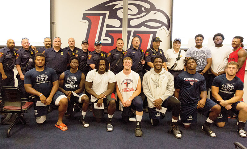 Members of the Liberty Flames football team and Lynchburg Fire Dept.