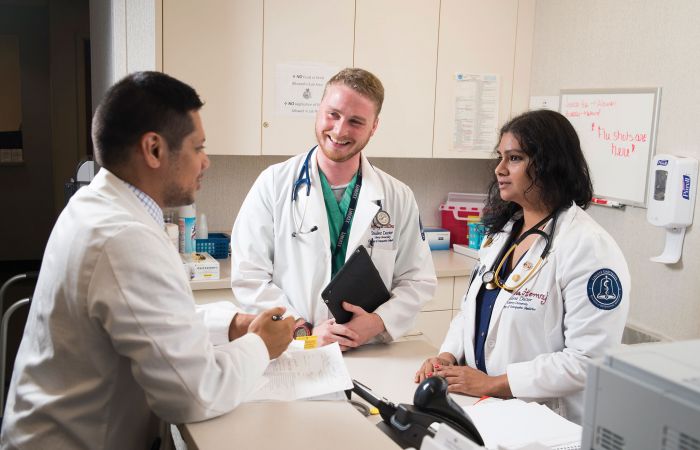 Third-year student-doctors (from left to right) Ernesto Enrique, Jeffrey Collins, and Nia Hemraj are working at the Danville Regional Medical Center, completing their clinical rotations.
