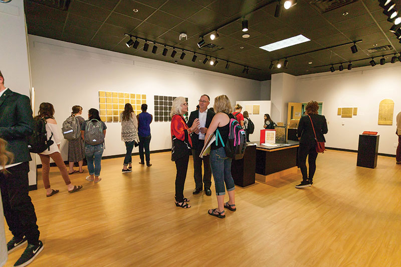 Guests attend the opening of the Reflections of Glory art exhibition at Liberty University.