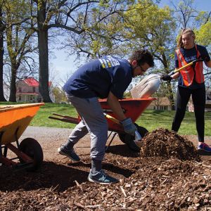 Students do yardwork at the Yoder Community Garden in Lynchburg.