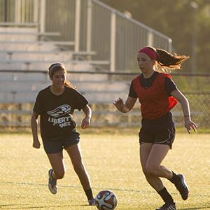 Two Liberty University students playing intramural soccer.