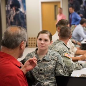 Senior Elisa Lyon, a nursing student/reserve officer receives instruction from retired military personnel during a military mentorship meeting. 