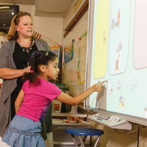 A second-grade student at Boonsboro Elementary School works on a smartboard, a digital projector that allows students to go to the front of the classroom and interact with the entire class while the teacher is presenting the lesson.