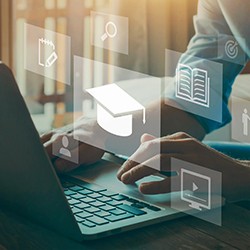 Image of someone working on a laptop with scholarly icons floating in front of the screen, including a graduation cap, a book, a magnifying glass.