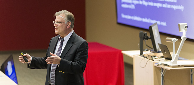 Dr. Bauer leads research presentation.