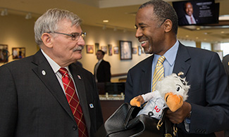 Dr. Ben Carson presented with "Doc Sparky" from Dr. Ronnie Martin, LUCOM dean.