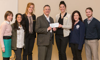 LUCOM-ACOOG officers accept grant from Dr. Eric Carlson.