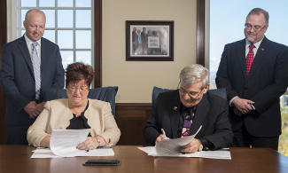 Teresa Rutherford, Dr. Ronnie Martin sign agreement