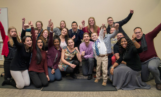 Student-doctors pose for a group photo with Myles.