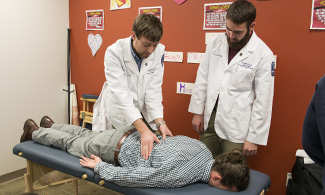 LUCOM student-doctors offer OMM treatment during November's medical outreach in Martinsville, Va.