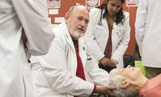 Ray L. Morrison, D.O., offers OMM demonstrations to LUCOM student-doctors.