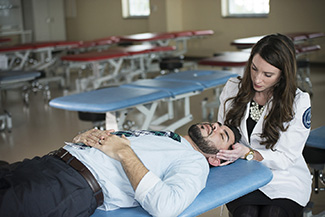 Student-doctors practice their OMM skills.