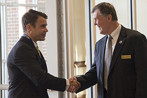 Gary L. Patton, PhD, assistant dean of Admissions and Student Services, greets new student.