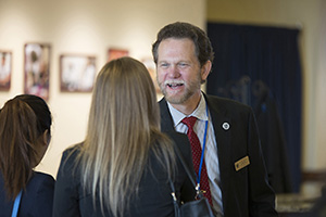 Peter A. Bell, DO, dean of LUCOM, greets new student.