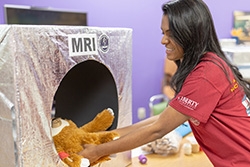 Liberty osteopathic medical student uses a homemade MRI machine to scan a teddy bear.