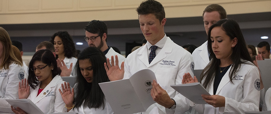 LUCOM student-doctors recite the osteopathic oath during the annual White Coat Ceremony.