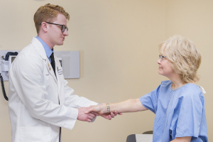 A Liberty osteopathic medical student introduces himself to a LUCOM standardized patient.
