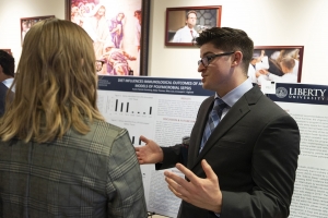 A LUCOM student-doctor presents his research findings through a research poster.