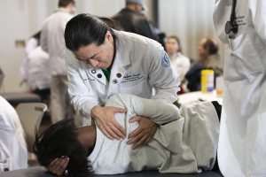 A LUCOM student-doctors provides osteopathic manipulative treatment to a patient during the Community Care Collaborative | Martinsville.
