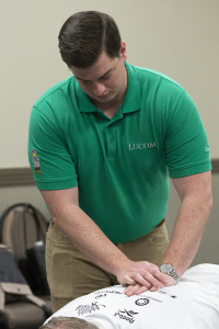 A LUCOM student-doctor provides osteopathic manipulative treatment (OMT) to an athlete during annual CrossFit Krypton’s Compete for a Cure competition.