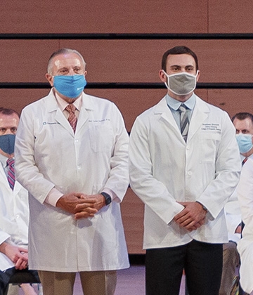 LUCOM student-doctor Brenner Johnson pictured with his grandfather Juan Carlos Giachino, Sr., MD.