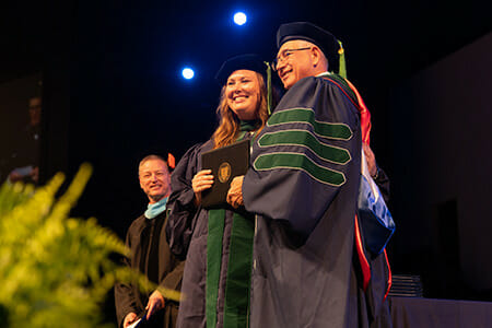 LUCOM Dean Joseph R. Johnson, DO, FACOOG (Dist) pictured with Abigail Barley, DO, shortly after being hooded.