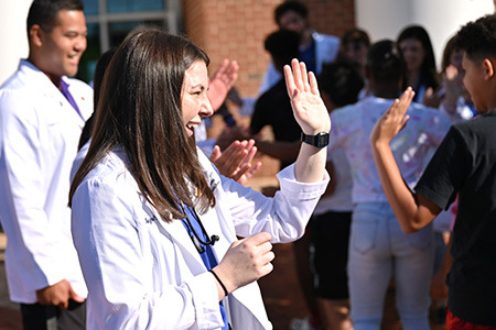 Liberty University osteopathic medical students welcome kids from the Jubilee Family Development Center.