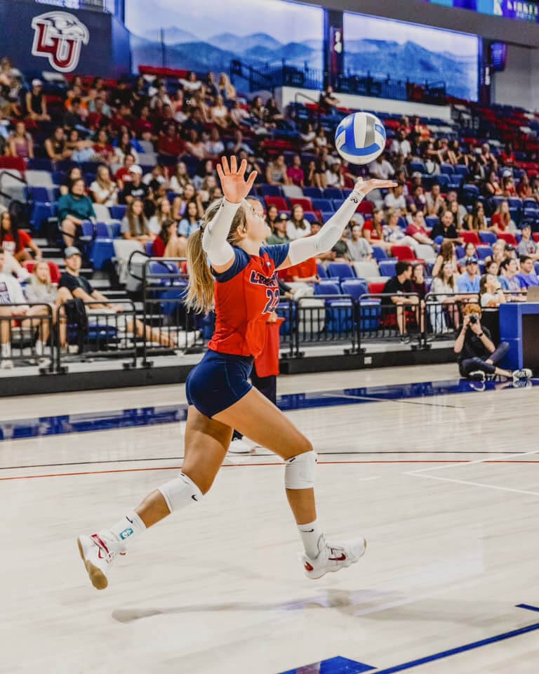 Girl serving a volleyball