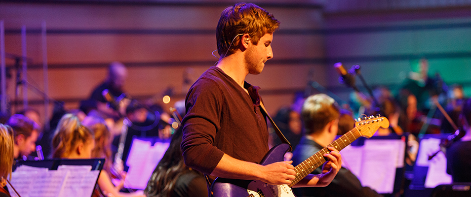 student playing electric guitar