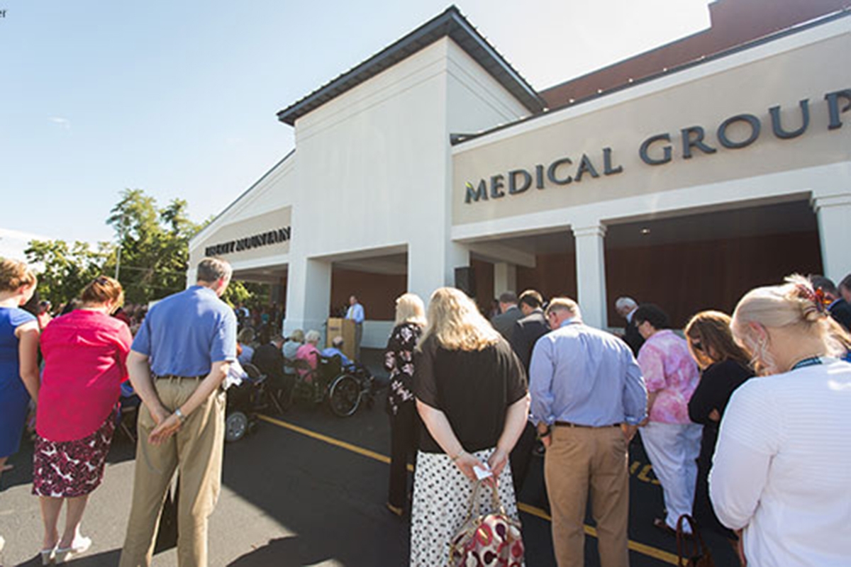 A crowd celebrates the ribbon cutting for the Liberty Mountain Medical Group clinic.