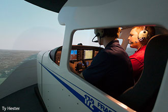 Liberty aeronautics students practice in a flight simulator.