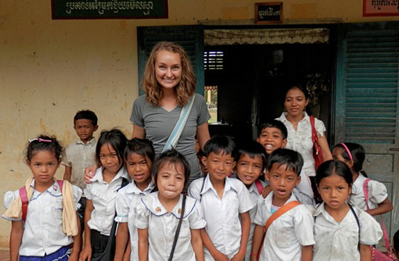 Liberty graduate Allison Braun with school children she taught in Cambodia.