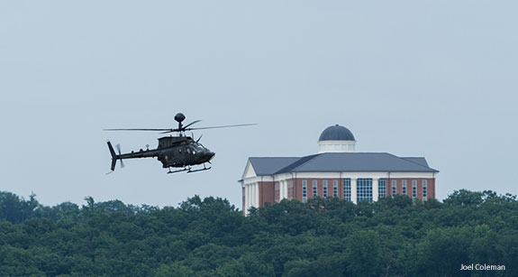 An army helicopter passes Liberty University's Center for Medical and Health Sciences as it prepares to land at Freedom Aviation.
