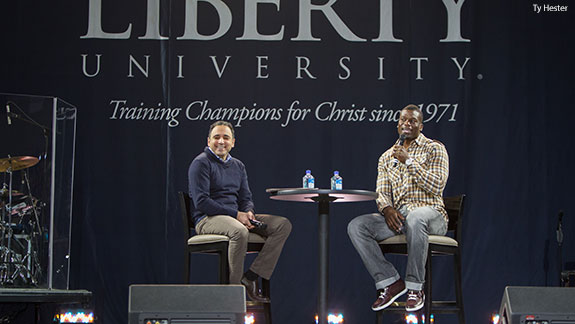 NFL tight end Ben Watson, alongside David Nasser, speaks during Liberty University Convocation.