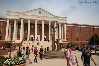 Liberty University students pass in and out of DeMoss Hall.