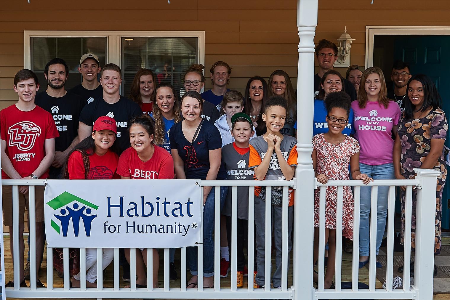 Habitat for Humanity club local family into their new home