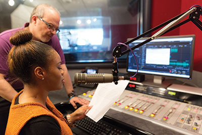 Imani Banks, a recent graduate, works at The Journey studio with Mike Weston, program director. 