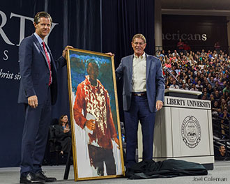 President Jerry Falwell accepts a painting depicting the last Bible translator.